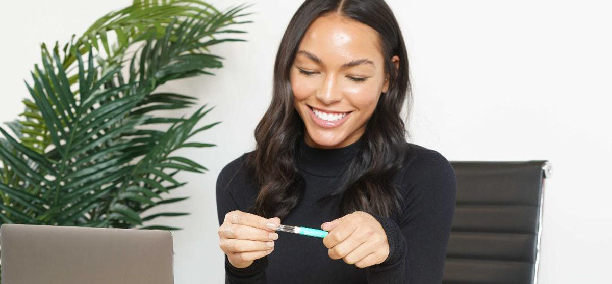 woman holding whitening gel